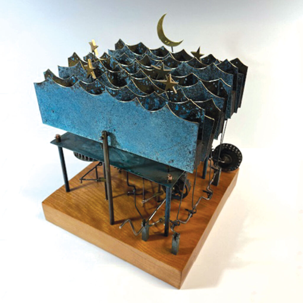 New kinetic sculpture alongside the current exhibit. A series of verdigris brass waves undulate with the turn of the crank while five stars slowly rotate back and fourth as a crescent moon slowly rises and sets. 
